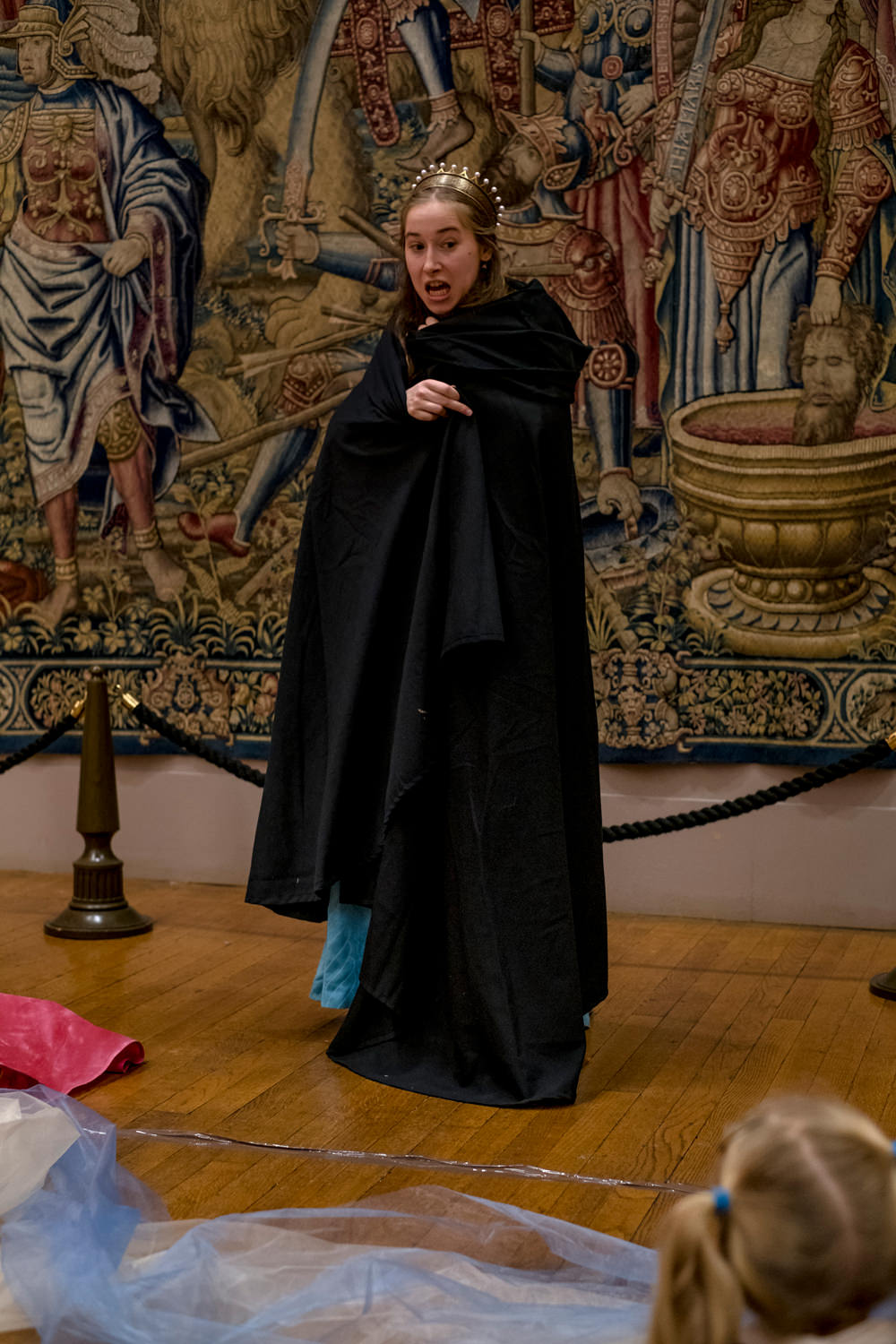 The actress wrapped in a black cloak