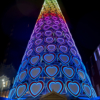 Looking up at the Christmas tree with one of the wooden huts in view