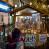 The two girls looking at a large nativity scene outside the shops