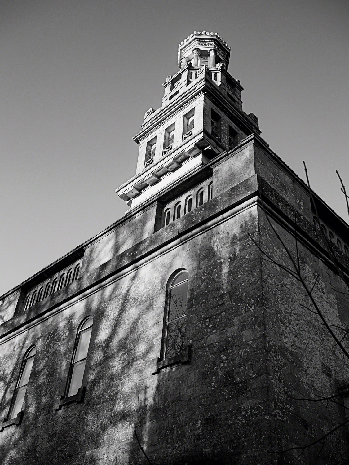 Looking up at Beckford's Tower. It's a square building with a tower on top. The tower has three distinct layers, each one smaller than the one below.