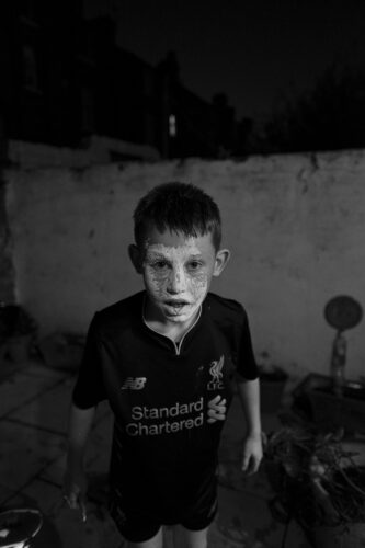 a boy with his face covered in flour