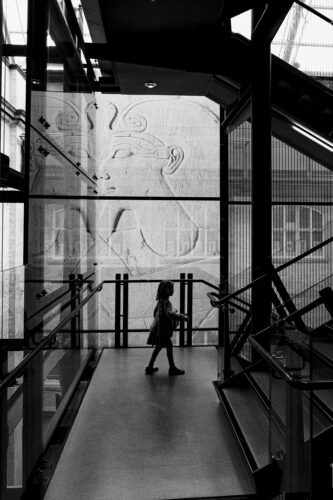 a girl walking down the stairs at the world museum in liverpool