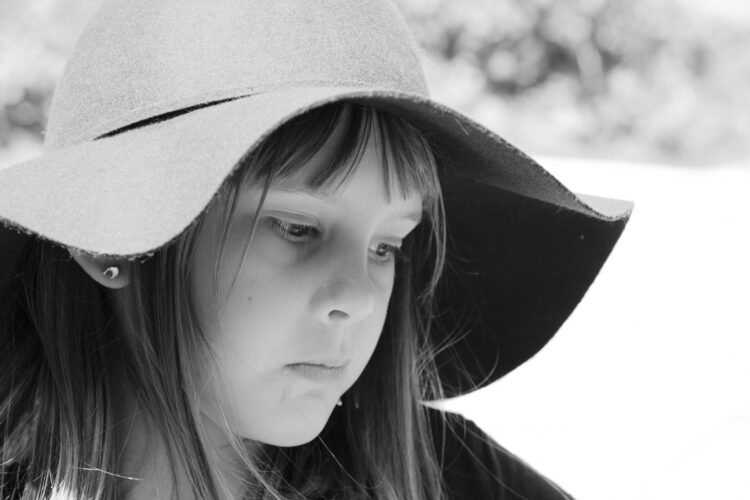 a girl wearing a wide-brimmed sun hat