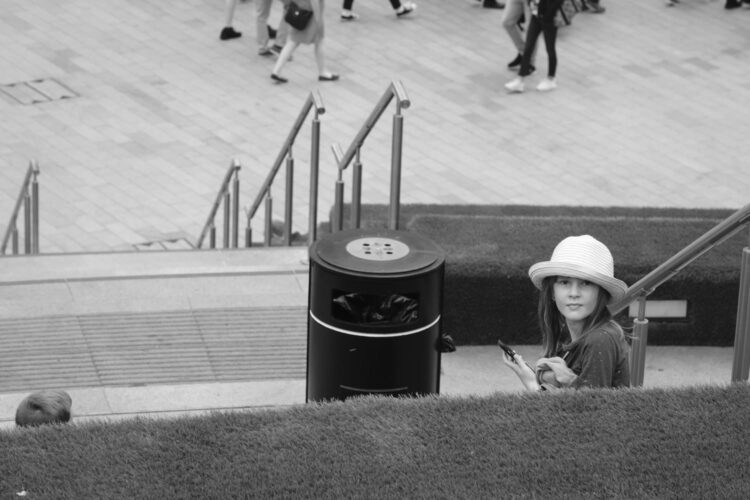 a girl sitting on a large set of outdoor stairs