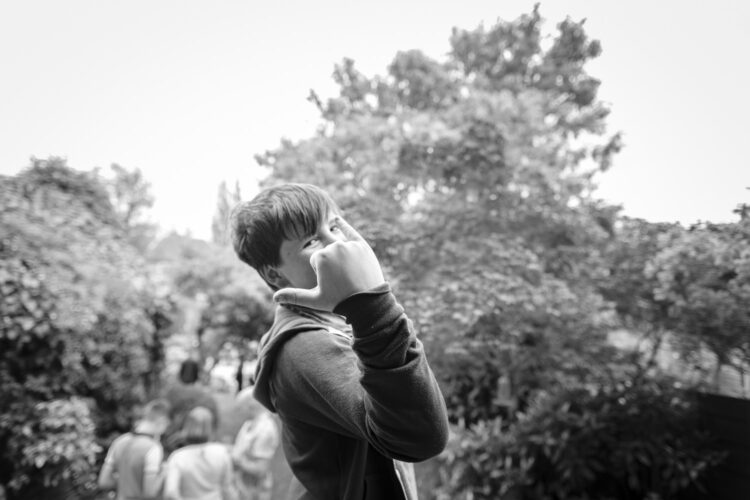 a boy with his hand up to the camera