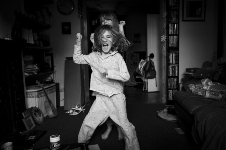 two girls dancing in a living room