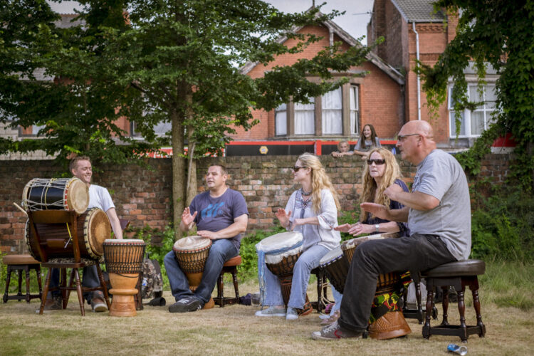 a group of drummers in a pub garden