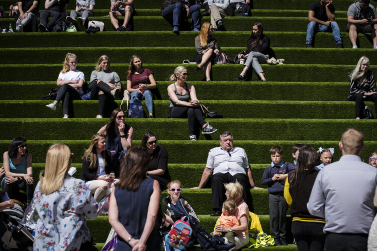 People sitting on a large set of steps at liverpool one