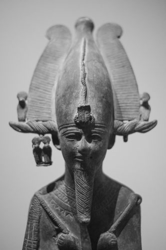 the top of a bronze statue of osiris