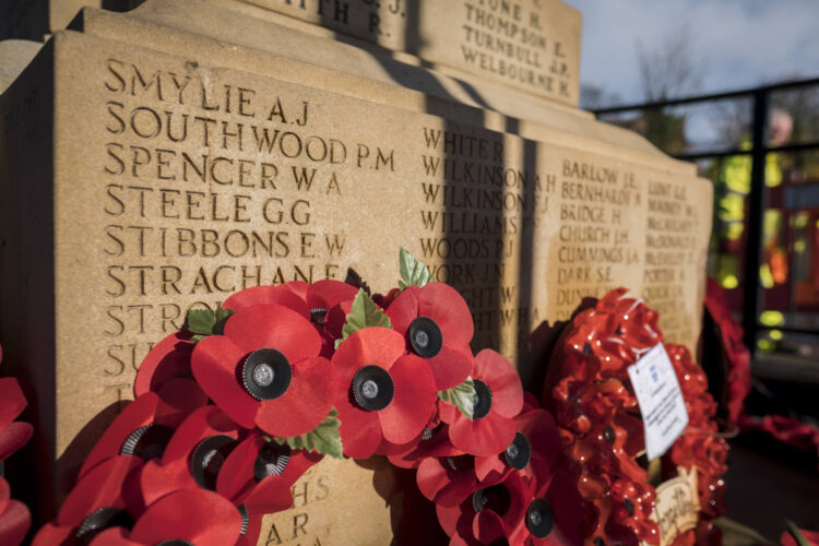 remembrance day poppies on a war memorial